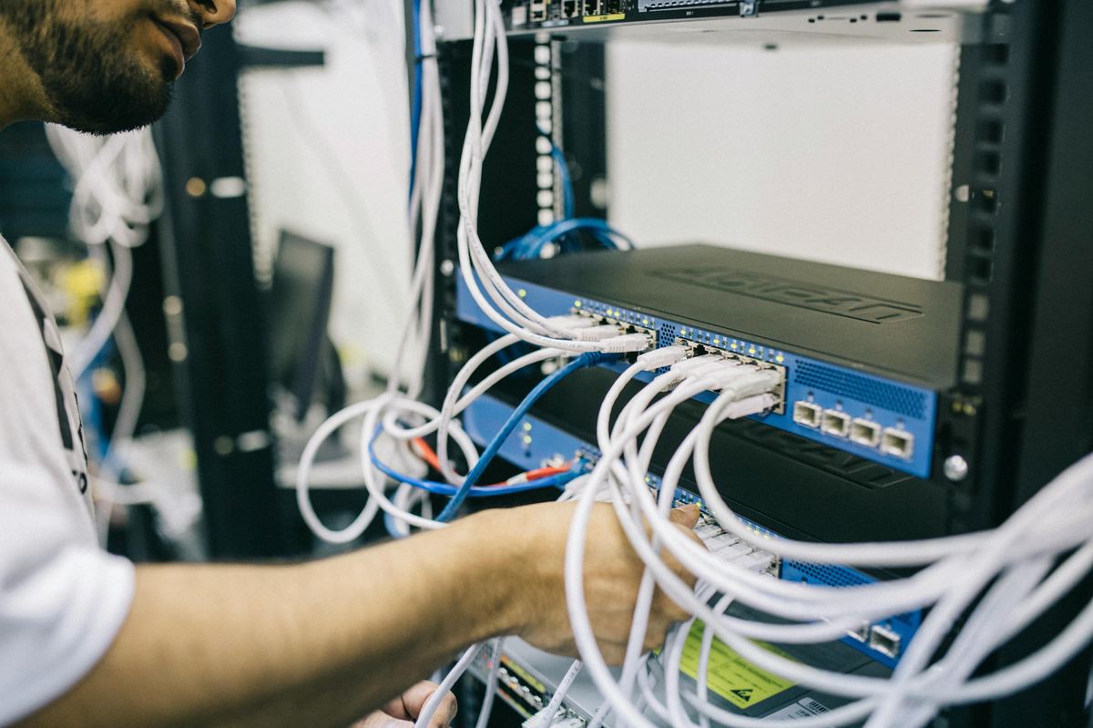 IT technician setting up network and security equipment